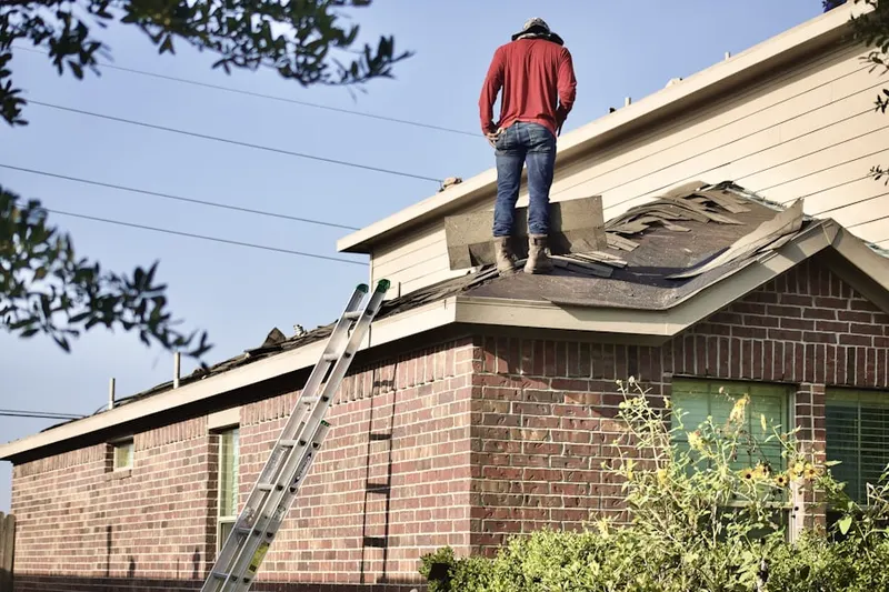 Professional roofer working on a residential roof in Willoughby